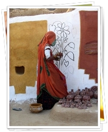 Woment painting her house at Khuri, Jaisalmer