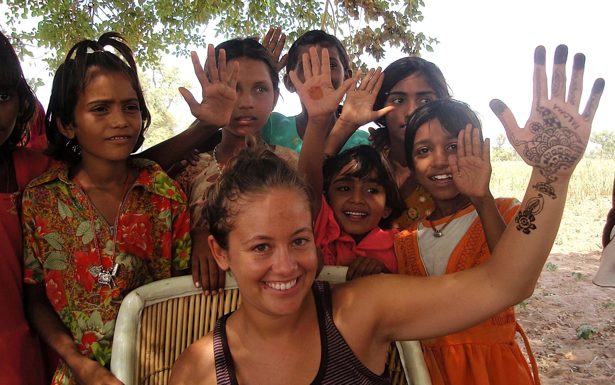 Rajasthan village experience – tourist family enjoying henna painting in India