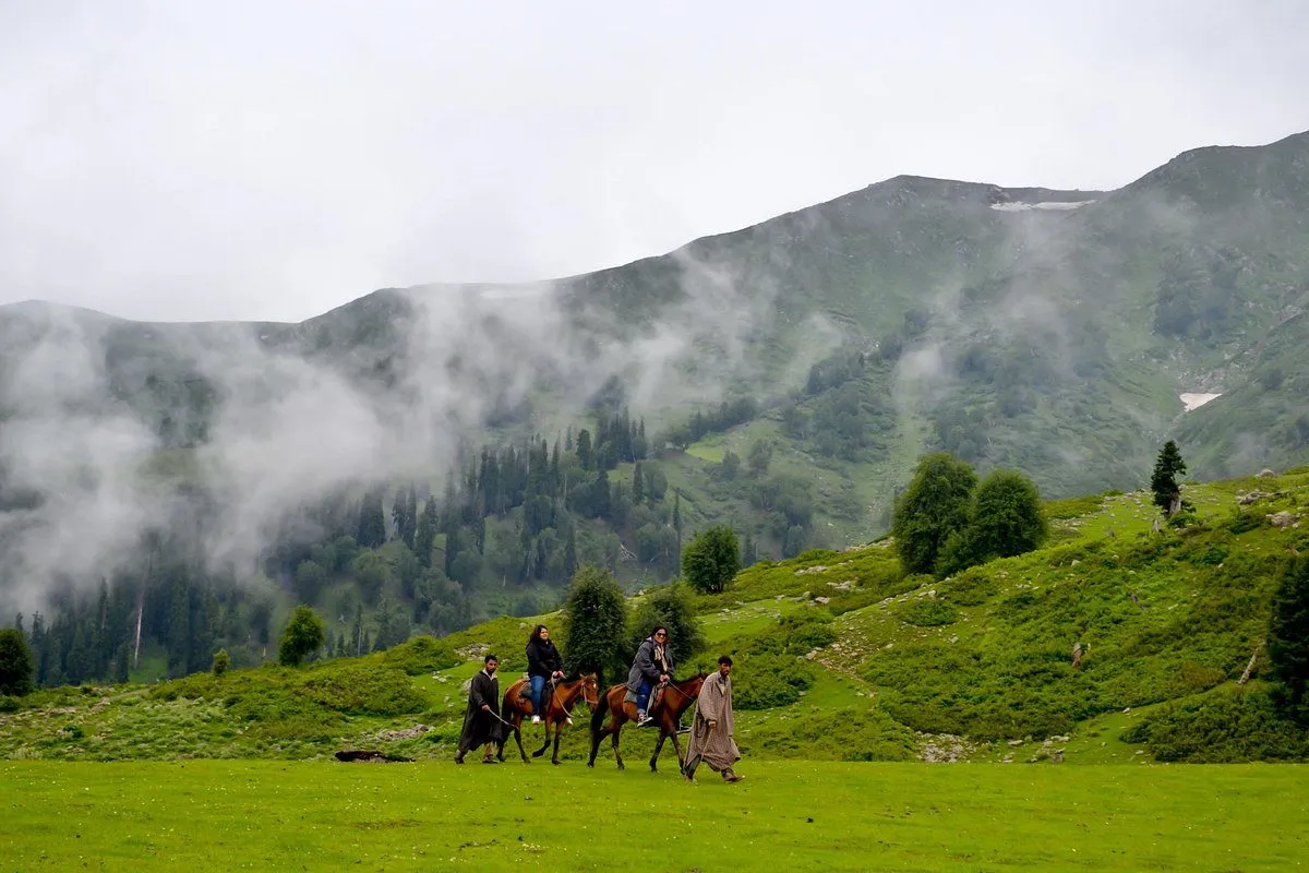 Tourist horse riding in a scenic valley with majestic Himalayan mountain views in the background