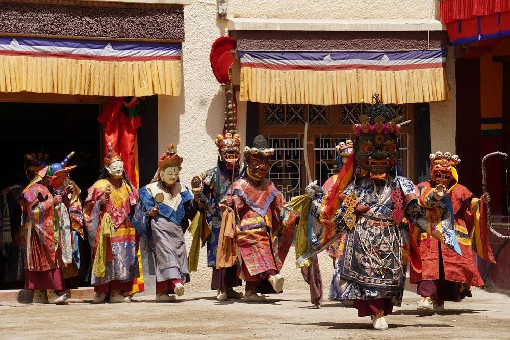 Buddhist monks performing the traditional Cham dance at Lamayuru Monastery during a colorful festival in Ladakh