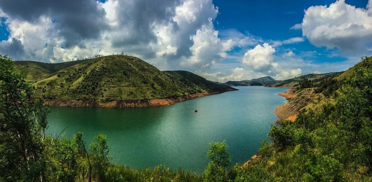 Scenic view of Upper Bhavani Lake in Ooty surrounded by lush green hills and calm blue waters.