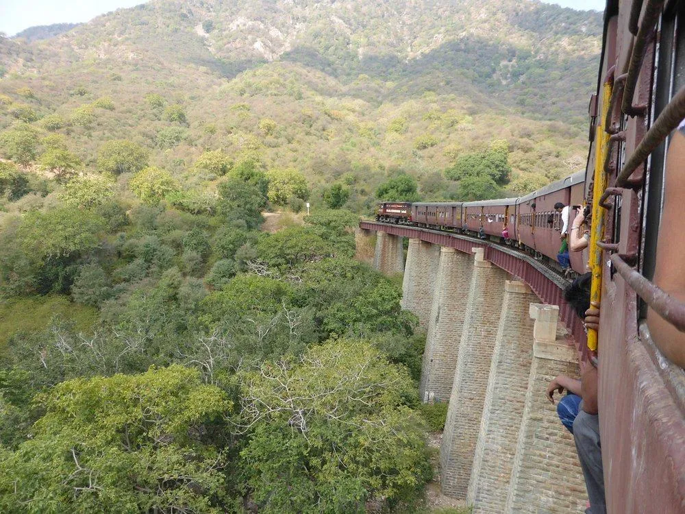 Heritage train passing through the scenic Kambli Ghat near Jojawar in the Aravalli Hills, Rajasthan